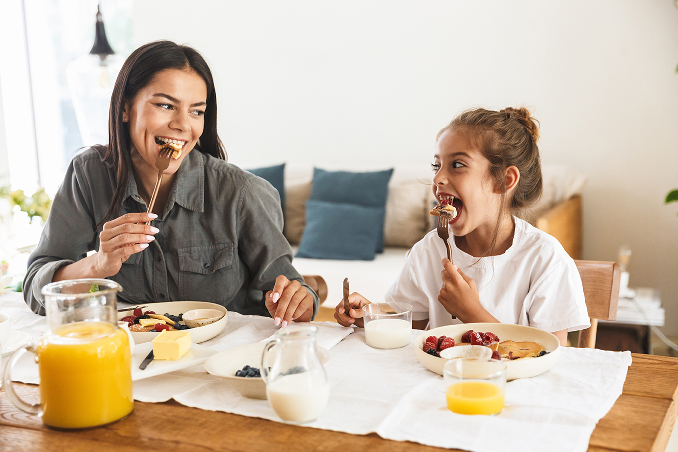 mother and daughter at breakfast table