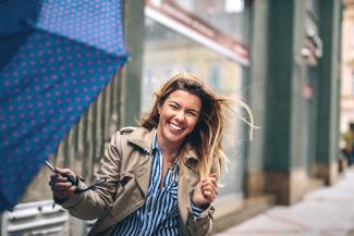 woman with umbrella in wind