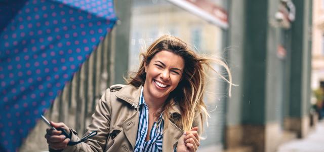 woman with umbrella in wind
