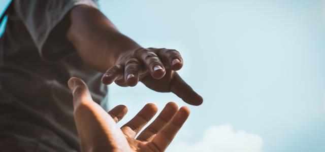 two hands reaching out for each other